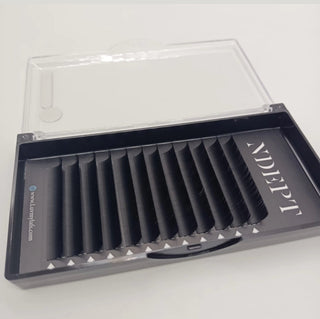 Eyelash extension tray with multiple pairs of lashes in a clear case on a white background